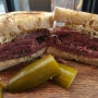 Hot pastrami on a multi grain bread with sourkraut, and homemade dill pickle.
